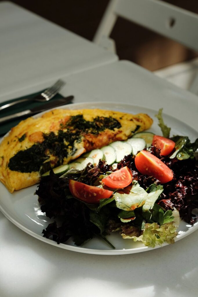 Healthy lunch with a vegetable omelet and fresh salad with tomatoes and cucumbers