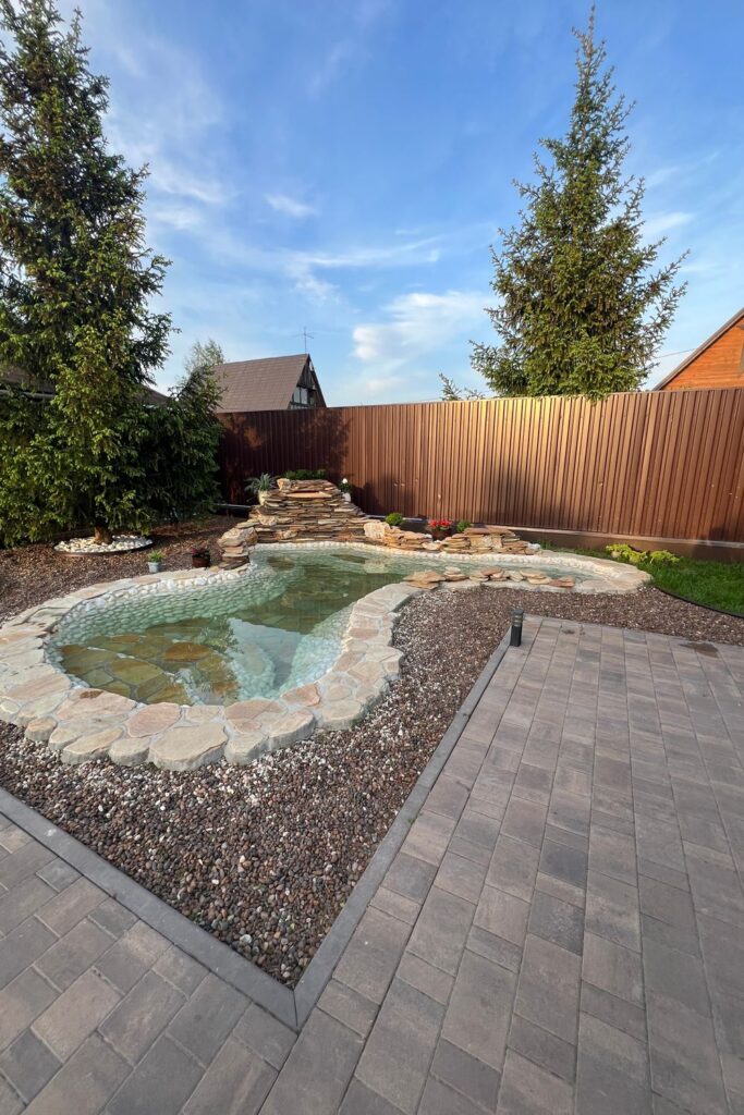 Clear backyard garden pond with stone edging, waterfall, and surrounding landscaping





    

Do you like this personality?