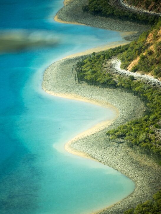 Turquoise water and rugged shoreline along the Kimberley coast in Western Australia.