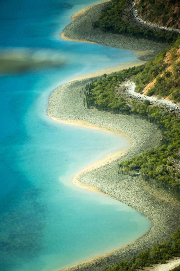 Turquoise water and rugged shoreline along the Kimberley coast in Western Australia.