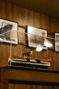 Detailed model passenger ship displayed inside a glass museum case