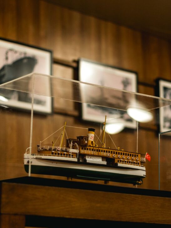 Detailed model passenger ship displayed inside a glass museum case