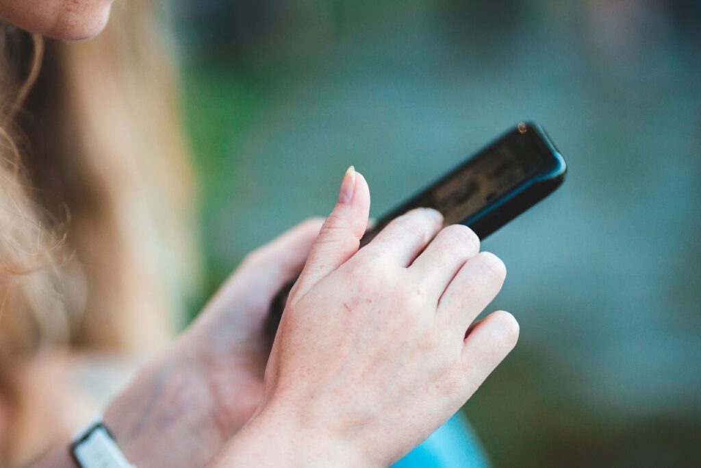 Woman using a smartphone while practicing smartphone privacy