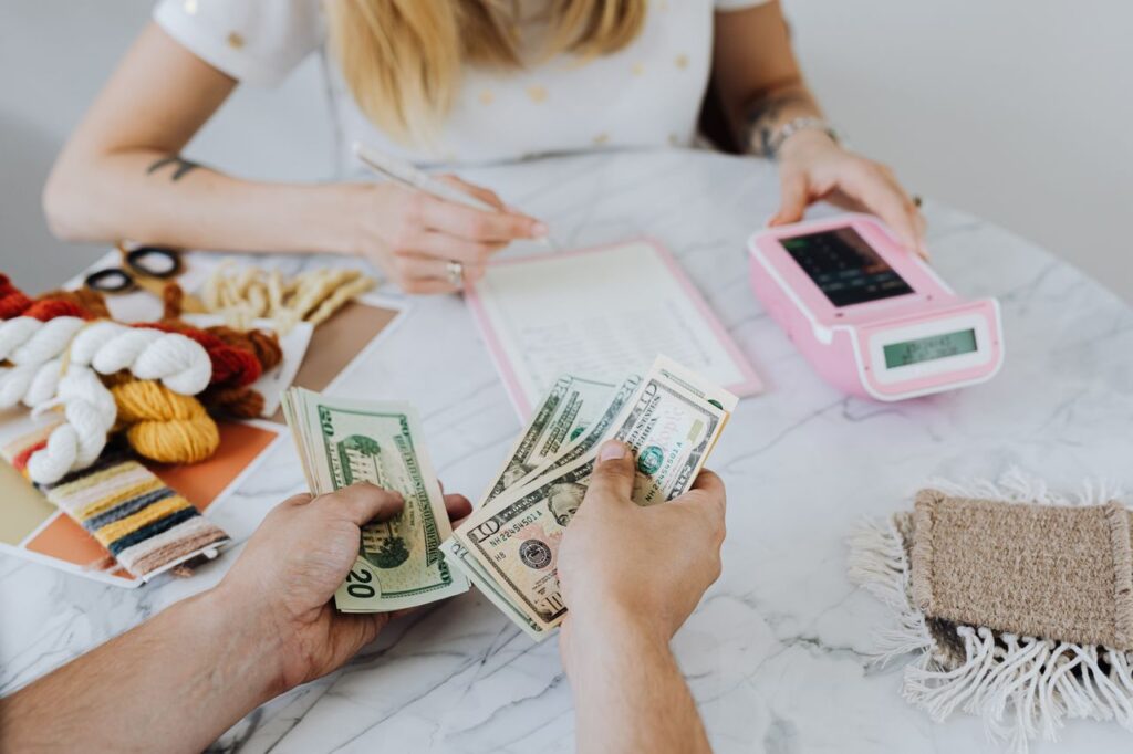 Wolman counting cash illustrating common fees that affect your budget.