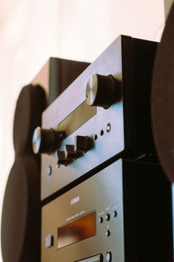 Stacked stereo components and speakers illustrating home audio upgrades.